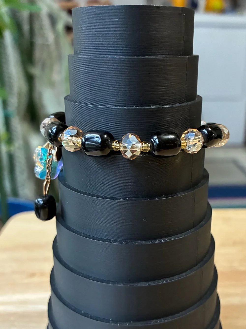 Black and Gold Beaded Stretch Bracelet with Iridescent Flower Charm - Picture 2 of 9
